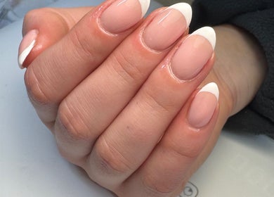 Elegant French manicure at All Things Beauty, Flitwick, England, GB. Perfectly shaped nails with glossy finish.