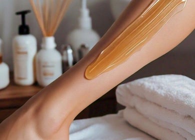 Leg with honey massage treatment at Sparadise, Calgary, Alberta, CA enhancing relaxation and skin health.