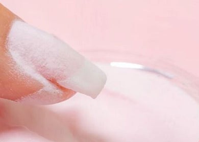 Close-up of finger with pink nail powder at Sparadise, Calgary, Alberta, CA.
