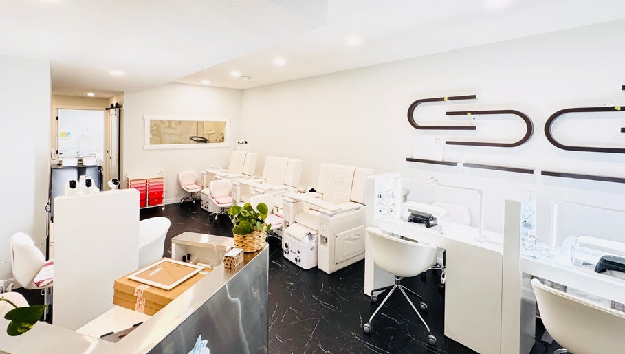 Modern nail salon interiors at Sparadise, Calgary, Alberta, CA, featuring stylish pedicure chairs and sleek decor.