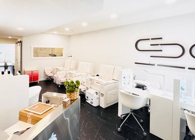 Modern nail salon interiors at Sparadise, Calgary, Alberta, CA, featuring stylish pedicure chairs and sleek decor.