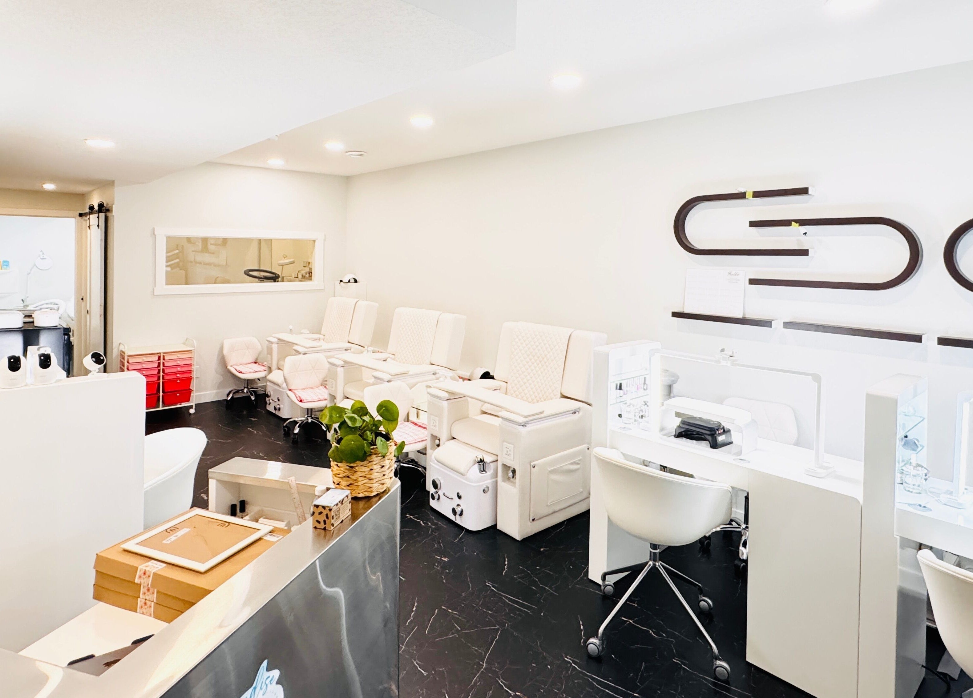 Modern nail salon interiors at Sparadise, Calgary, Alberta, CA, featuring stylish pedicure chairs and sleek decor.