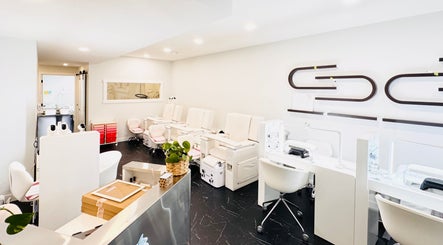 Modern nail salon interiors at Sparadise, Calgary, Alberta, CA, featuring stylish pedicure chairs and sleek decor.