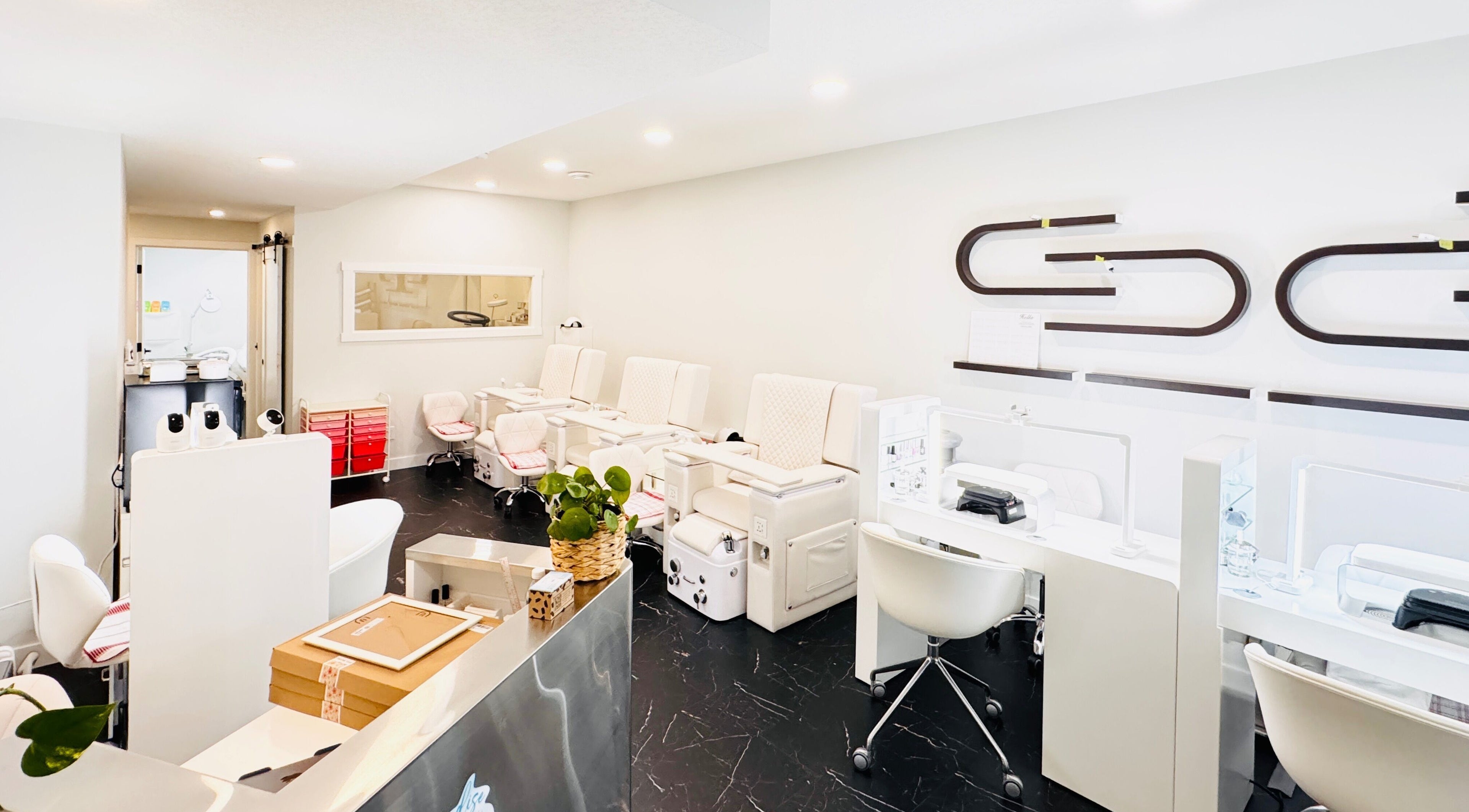 Modern nail salon interiors at Sparadise, Calgary, Alberta, CA, featuring stylish pedicure chairs and sleek decor.