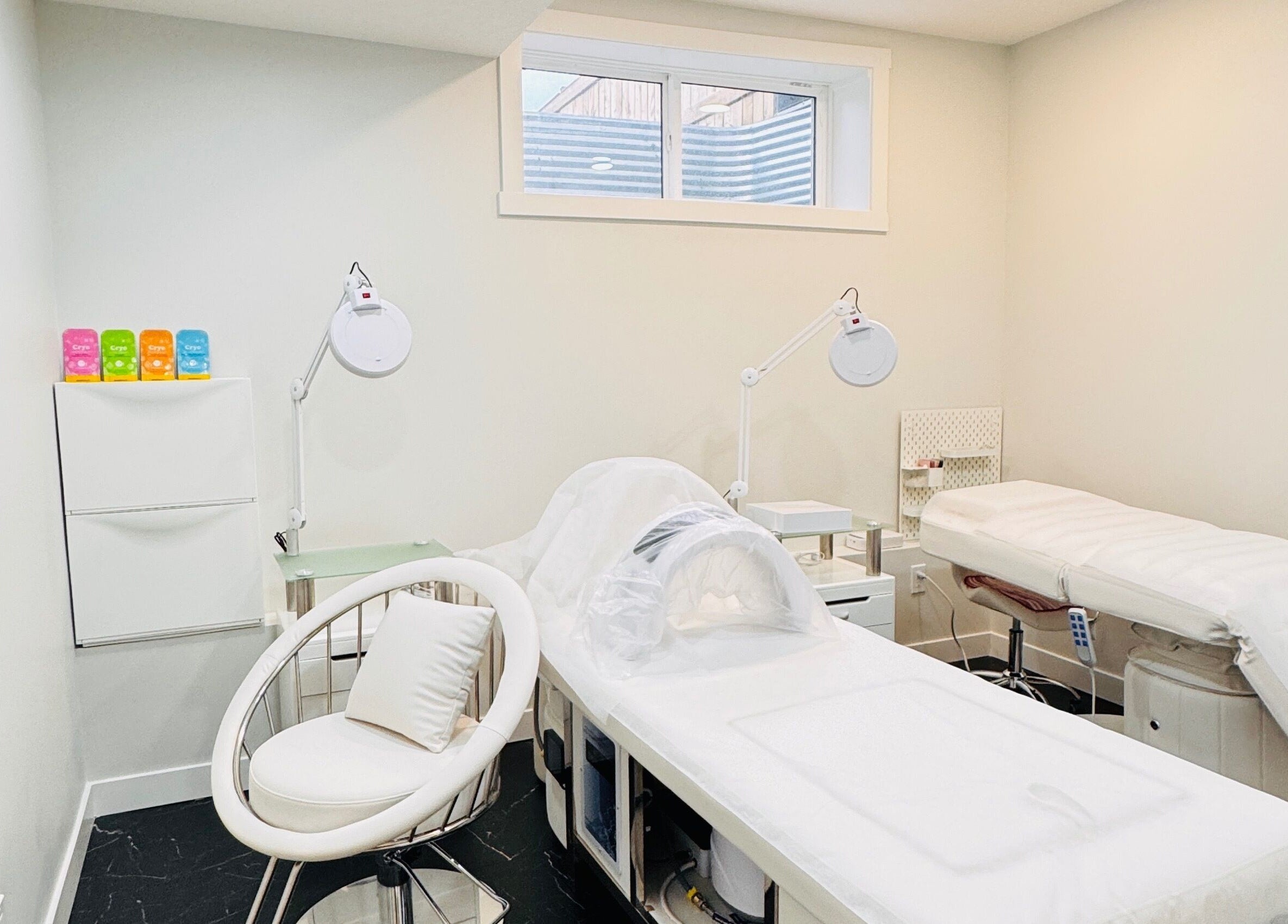 Calm treatment room at Sparadise, Calgary, Alberta, CA, featuring plush beds and soft lighting.