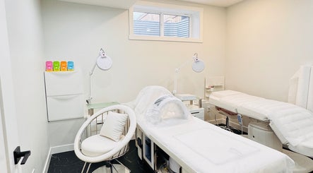 Calm treatment room at Sparadise, Calgary, Alberta, CA, featuring plush beds and soft lighting.