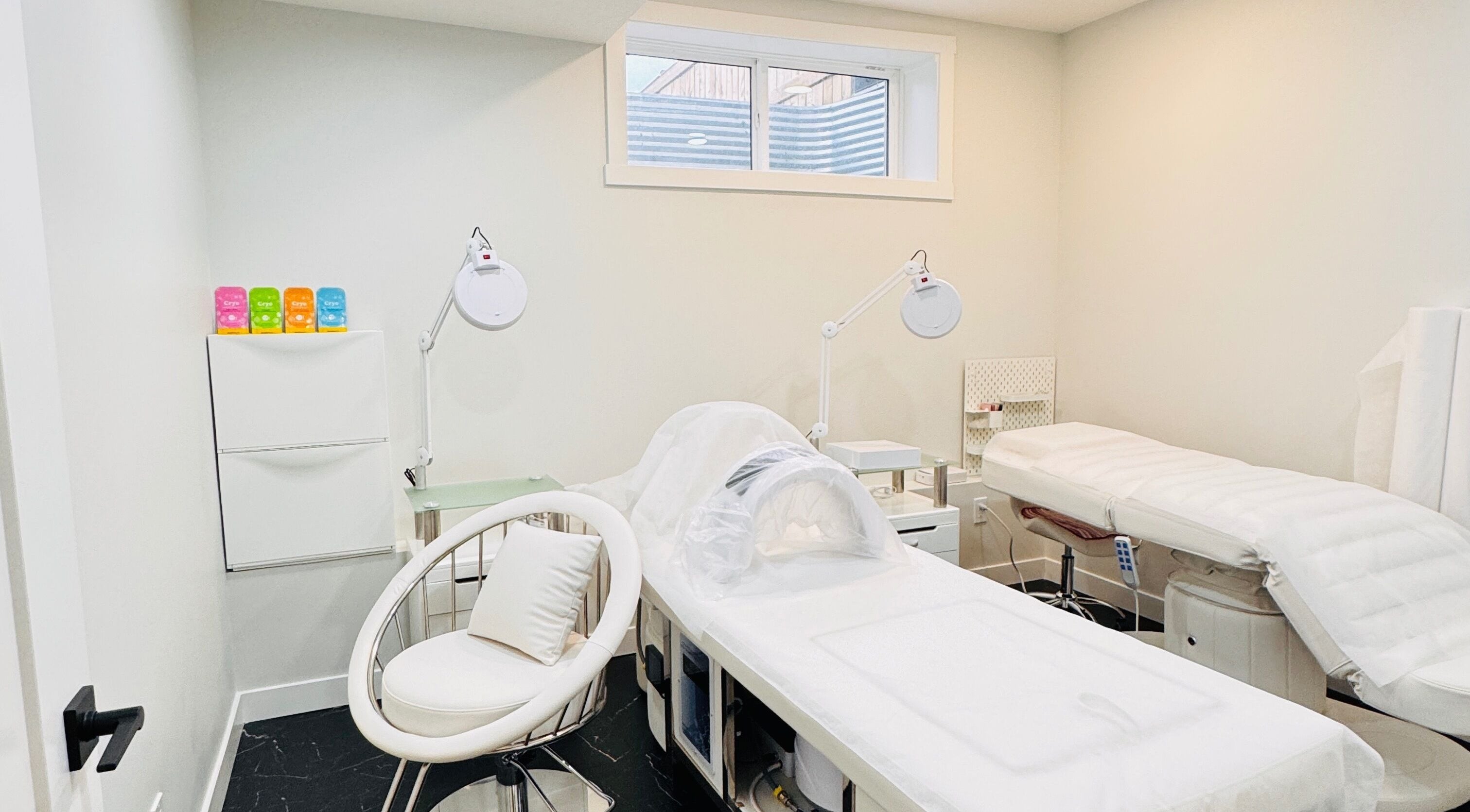 Calm treatment room at Sparadise, Calgary, Alberta, CA, featuring plush beds and soft lighting.