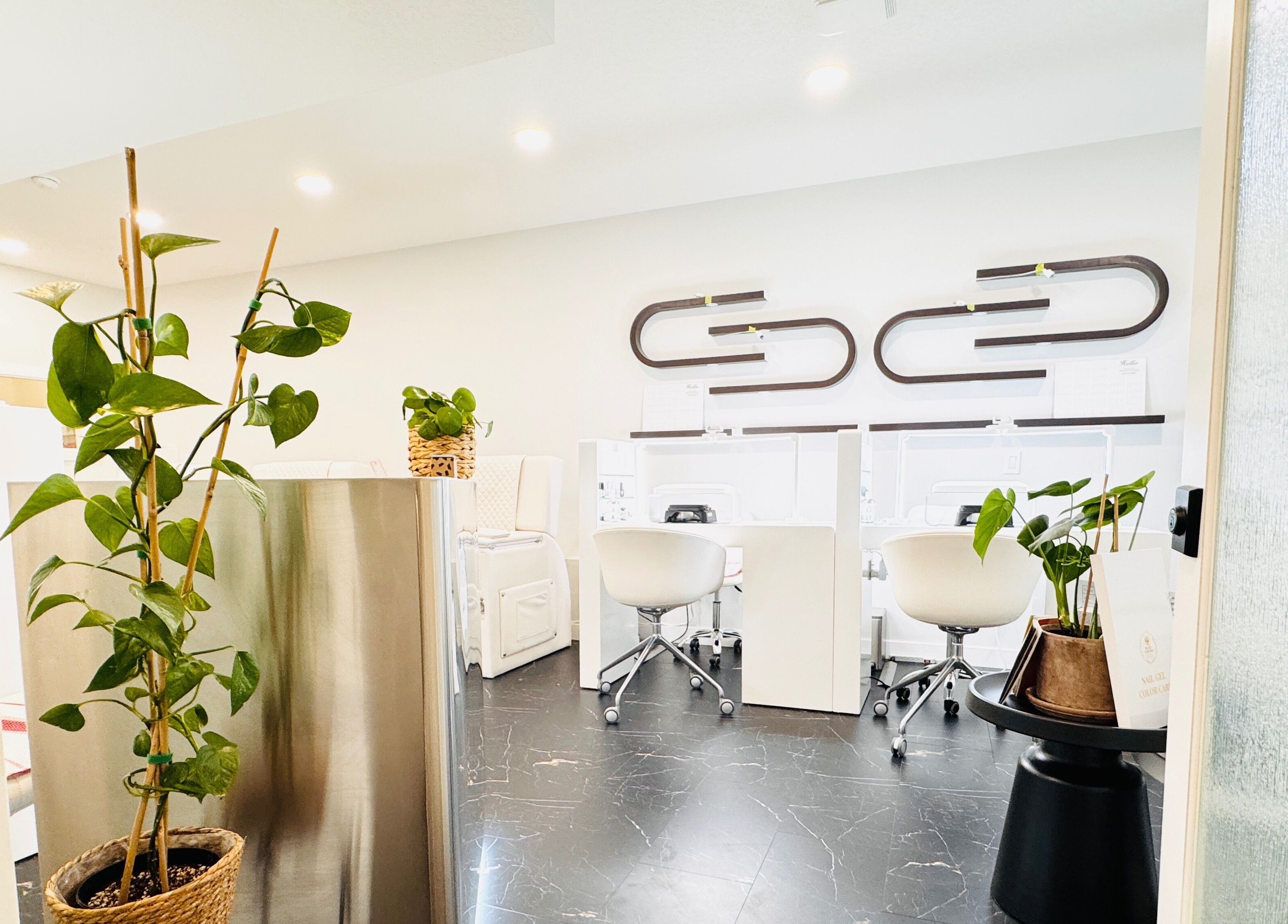Modern nail spa with lush plants at Sparadise, Calgary, Alberta, CA for a refreshing wellness experience.