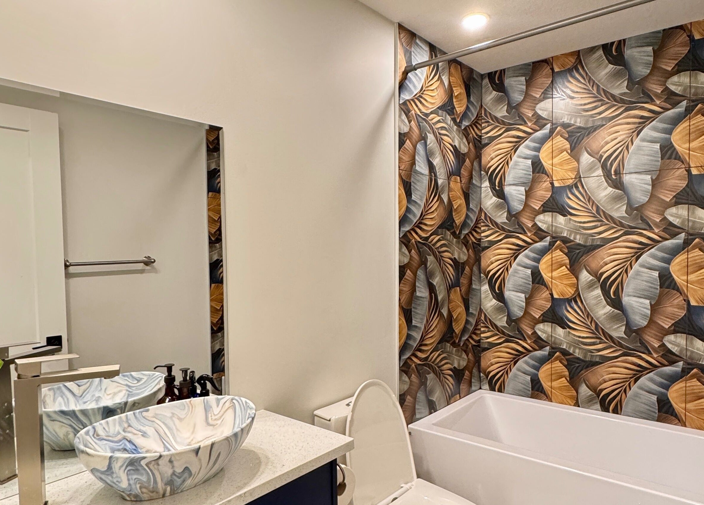 Elegant bathroom at Sparadise in Calgary, Alberta, CA featuring artistic tiles and a stylish marble sink.