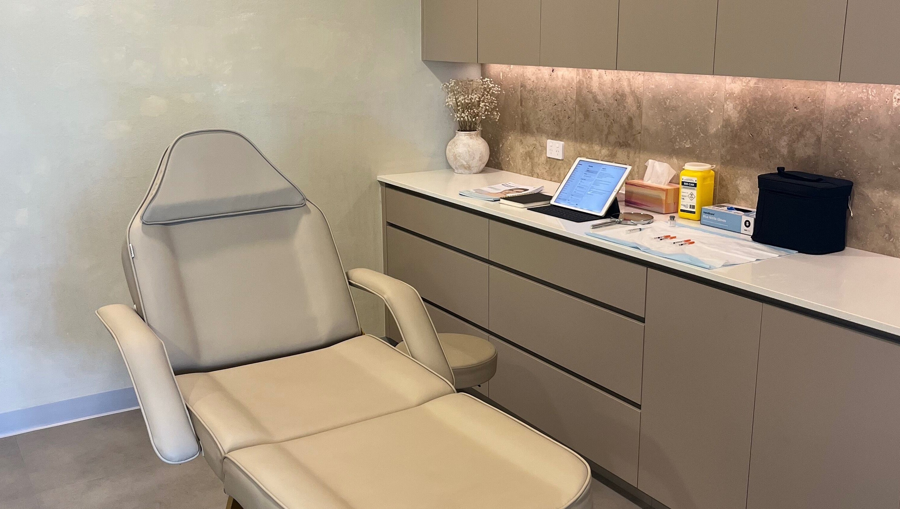 Aesthetic treatment room at Nadine Aesthetics, Pacific Pines, Queensland, AU with a plush reclining chair and equipment.