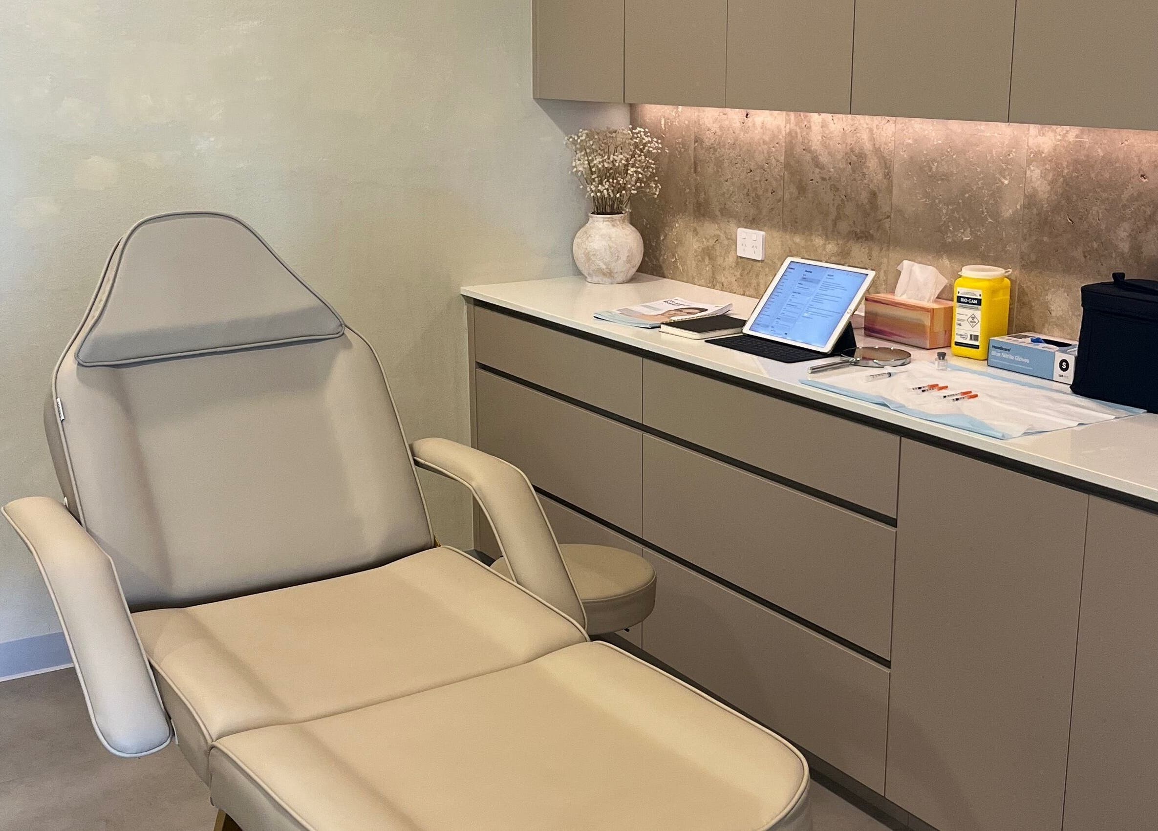 Aesthetic treatment room at Nadine Aesthetics, Pacific Pines, Queensland, AU with a plush reclining chair and equipment.