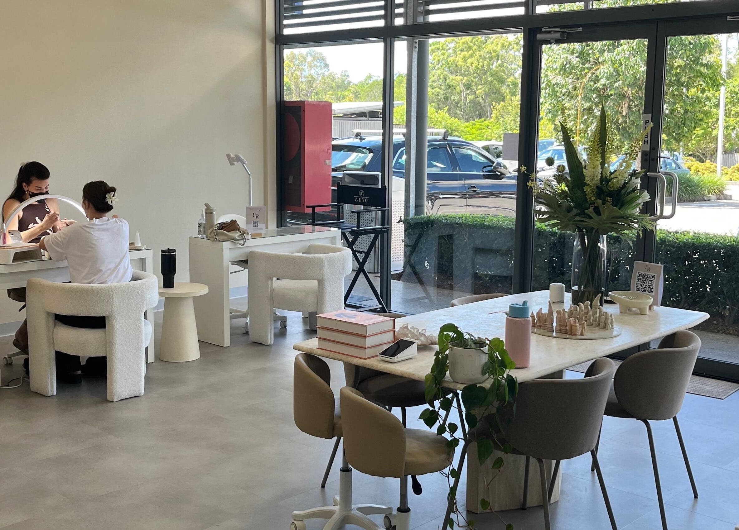 Nadine Aesthetics nail salon interior with client receiving treatment, Pacific Pines, Queensland, AU.