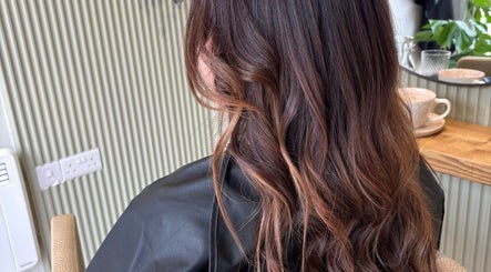 Long, wavy brunette hair styled at Hannah Marie Hair Studio, Hurstbourne Tarrant, England, GB.