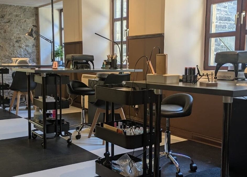 Modern nail studio setup at Claws and Pause, Edinburgh, Scotland, GB featuring sleek manicure stations.