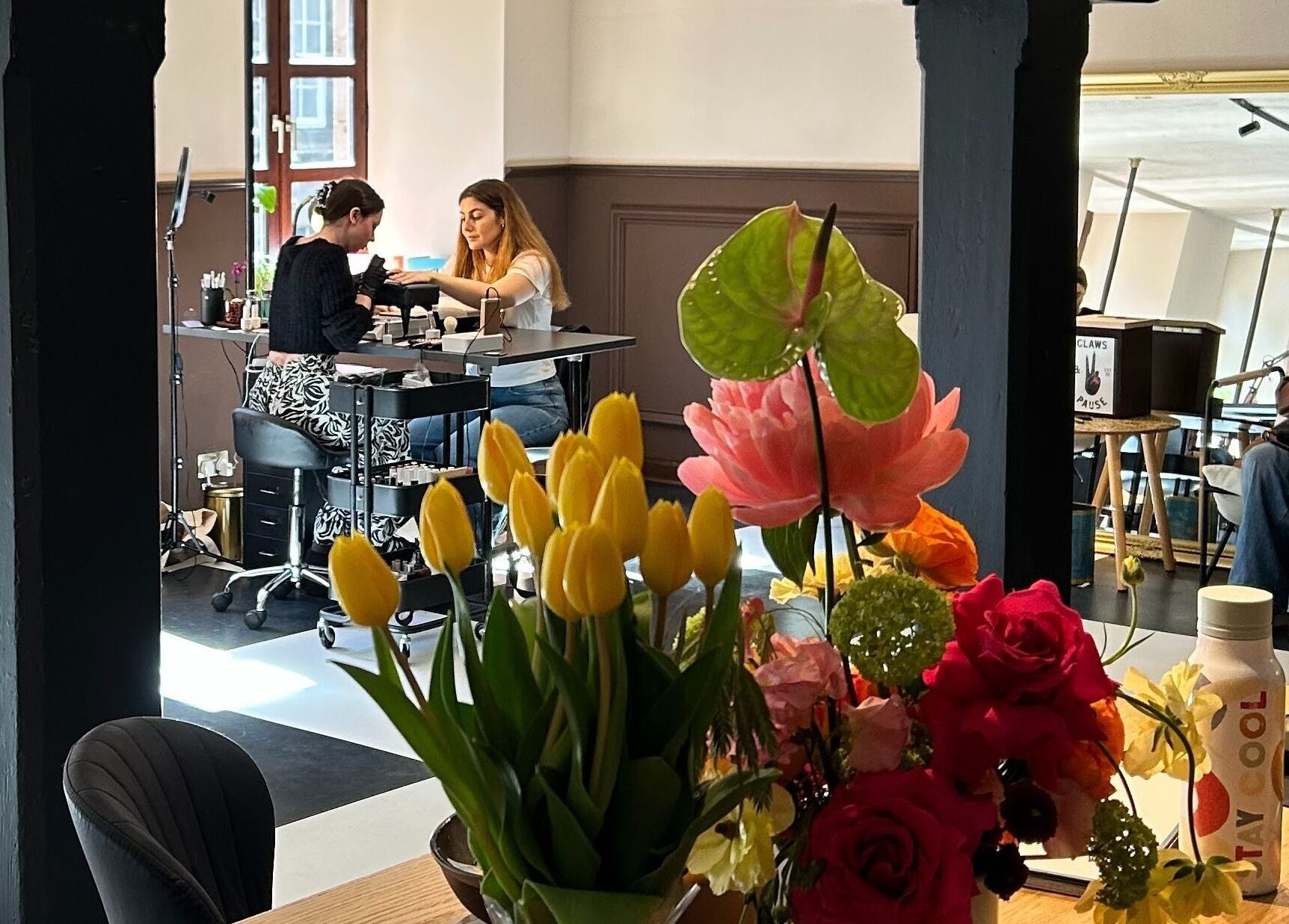 Nail care session at Claws and Pause, vibrant flowers, Edinburgh, Scotland, GB.