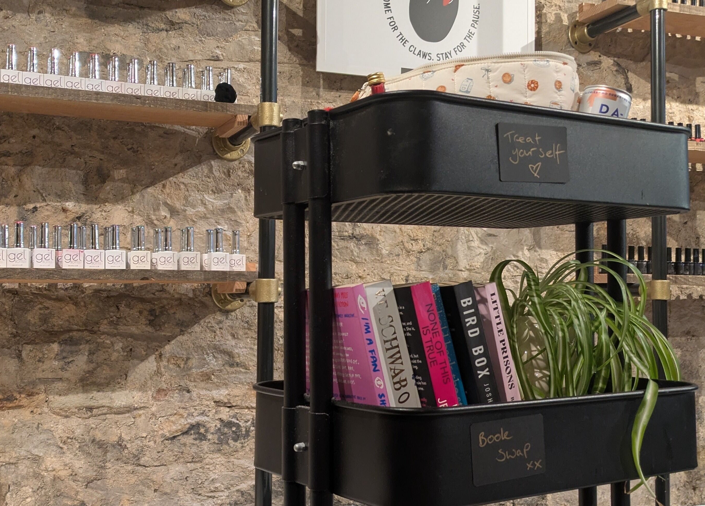 Claws and Pause shelf with nail polishes and books, Edinburgh, Scotland, GB. Modern, rustic decor.