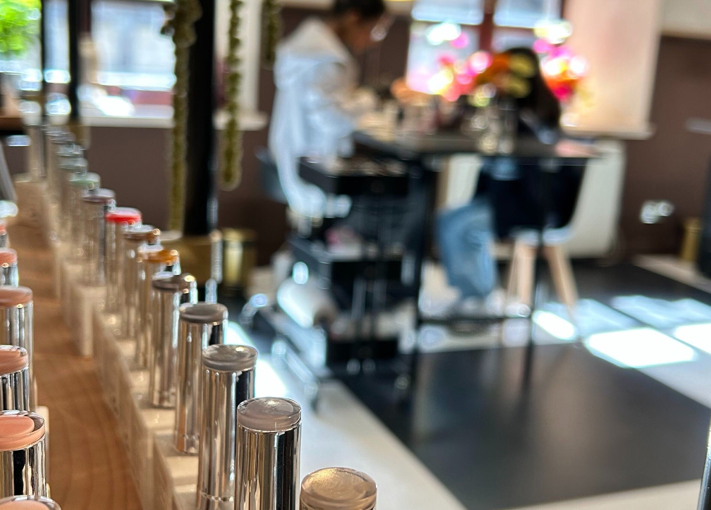 Claws and Pause in Edinburgh, Scotland, GB features a diverse nail polish selection and a cozy interior setting.