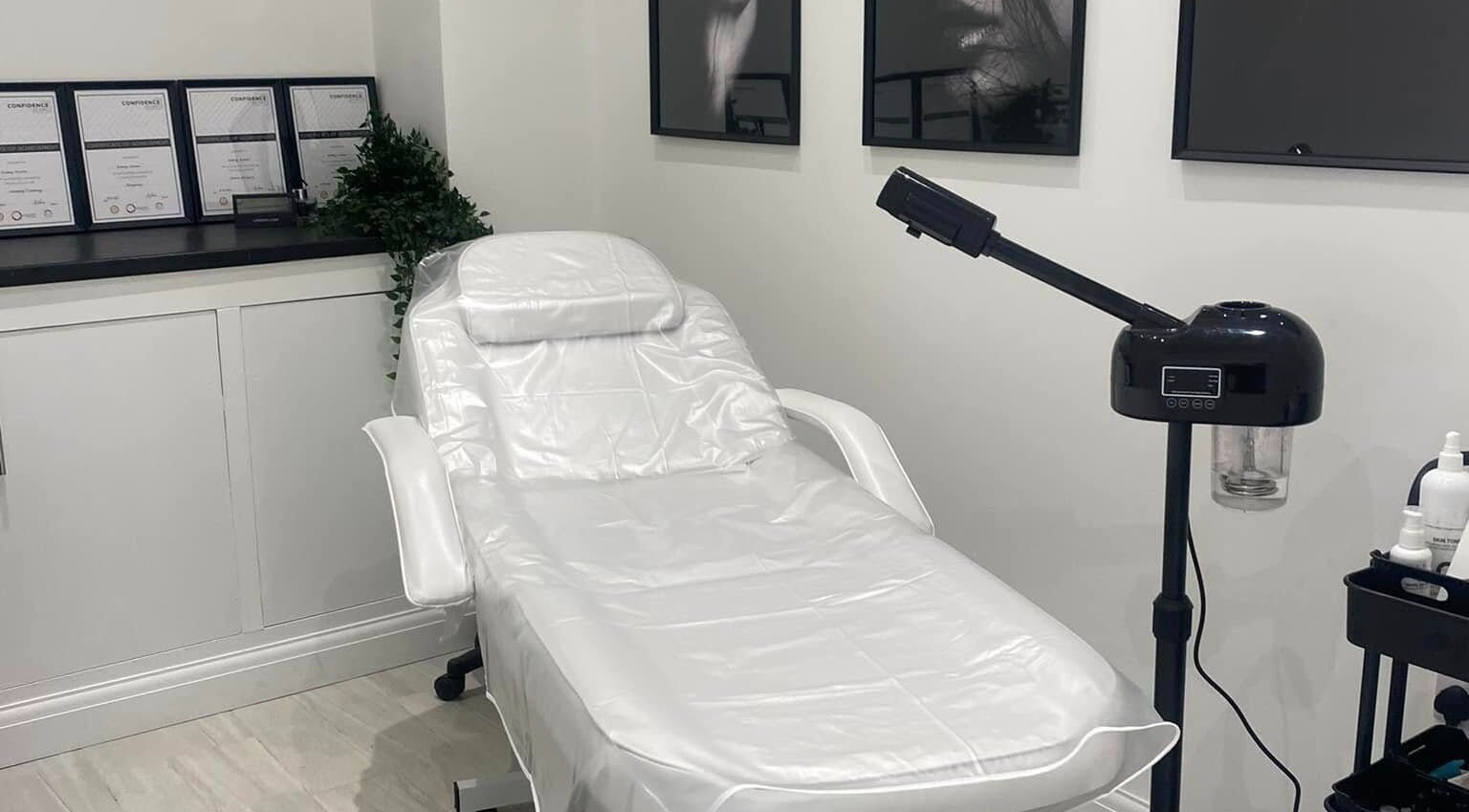 Relaxing treatment room at The Quartz Clinic, Hucknall, England, GB, featuring a sleek white therapy chair.