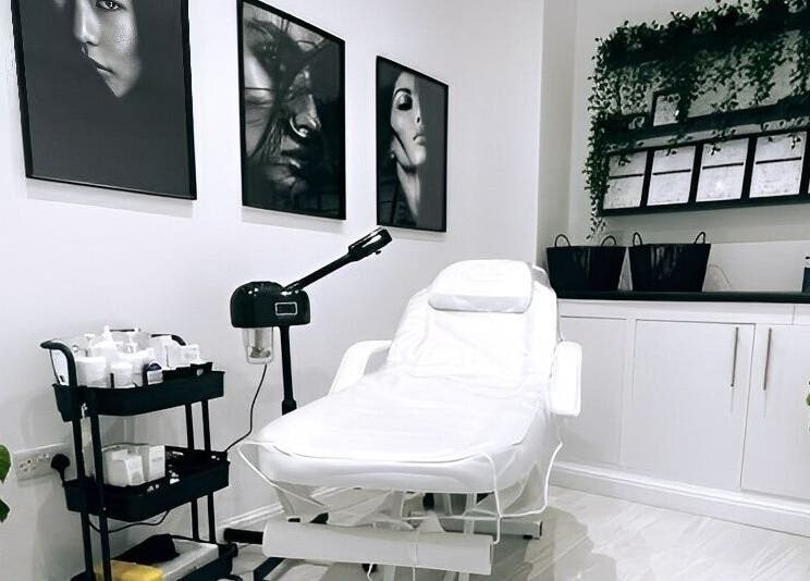 Relaxing treatment room at The Quartz Clinic, Hucknall, England, GB with a white spa chair and wall art.