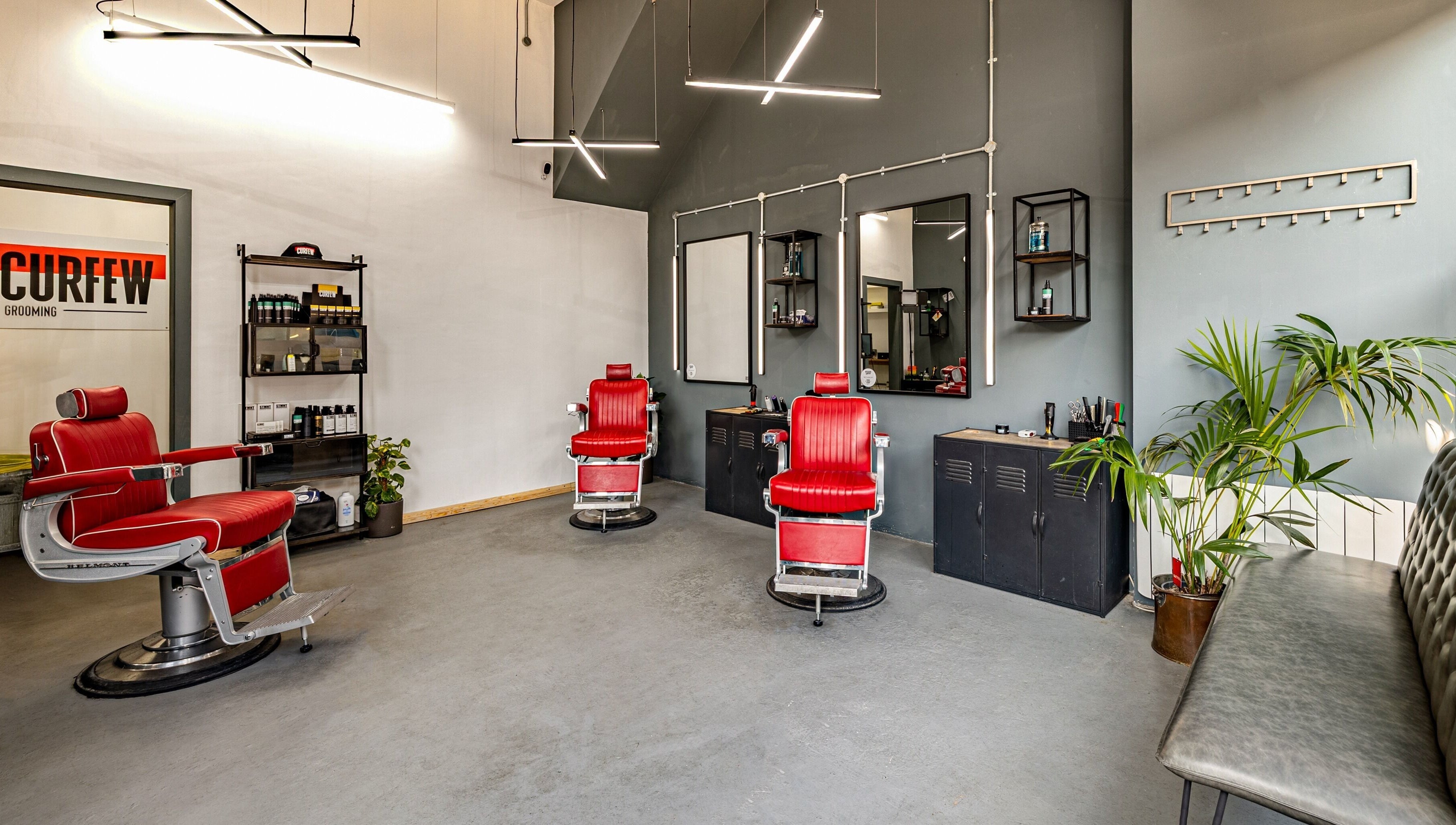 Modern barber chairs at Curfew Grooming Brixton, London, England, GB. Sleek design and inviting atmosphere.