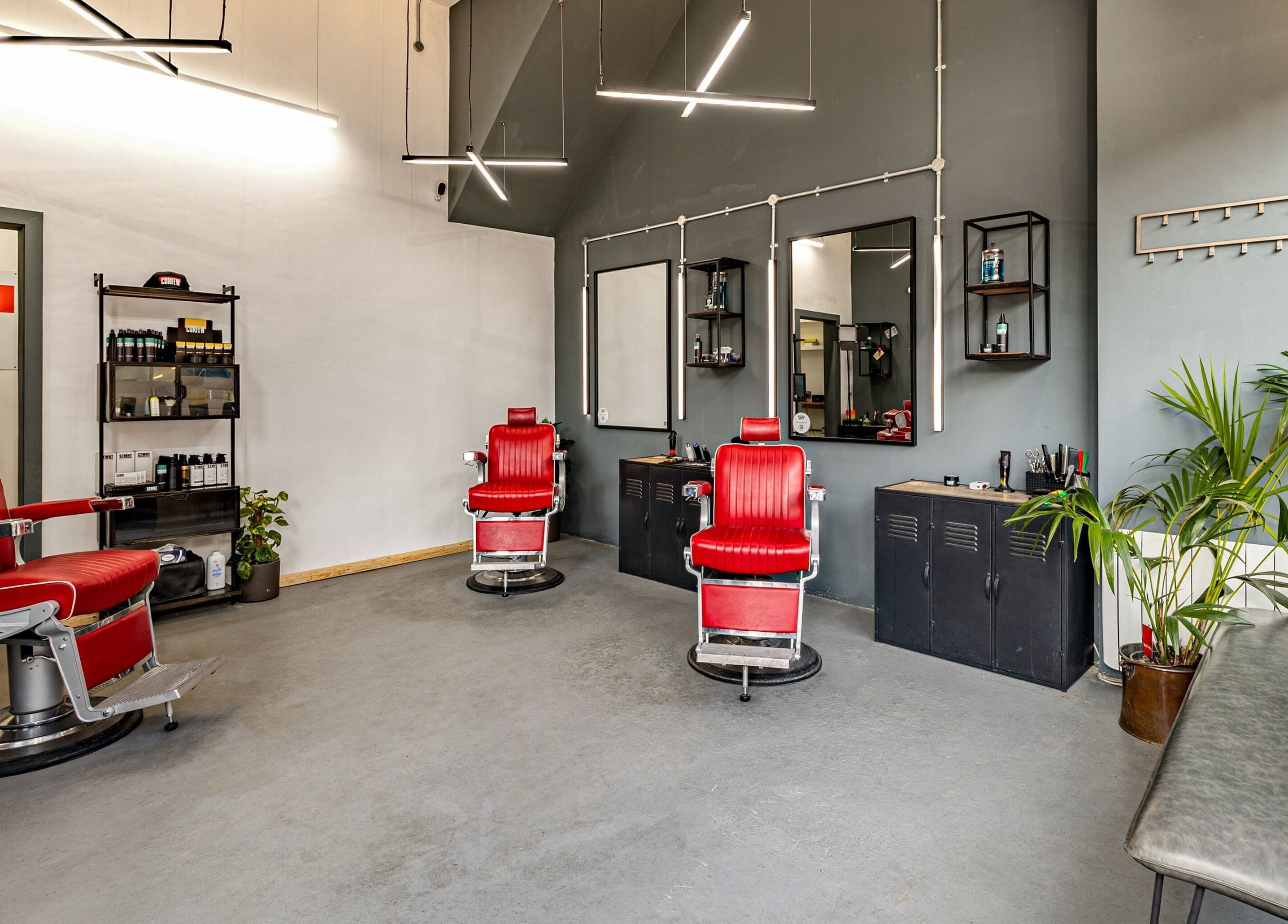 Modern barber chairs at Curfew Grooming Brixton, London, England, GB. Sleek design and inviting atmosphere.