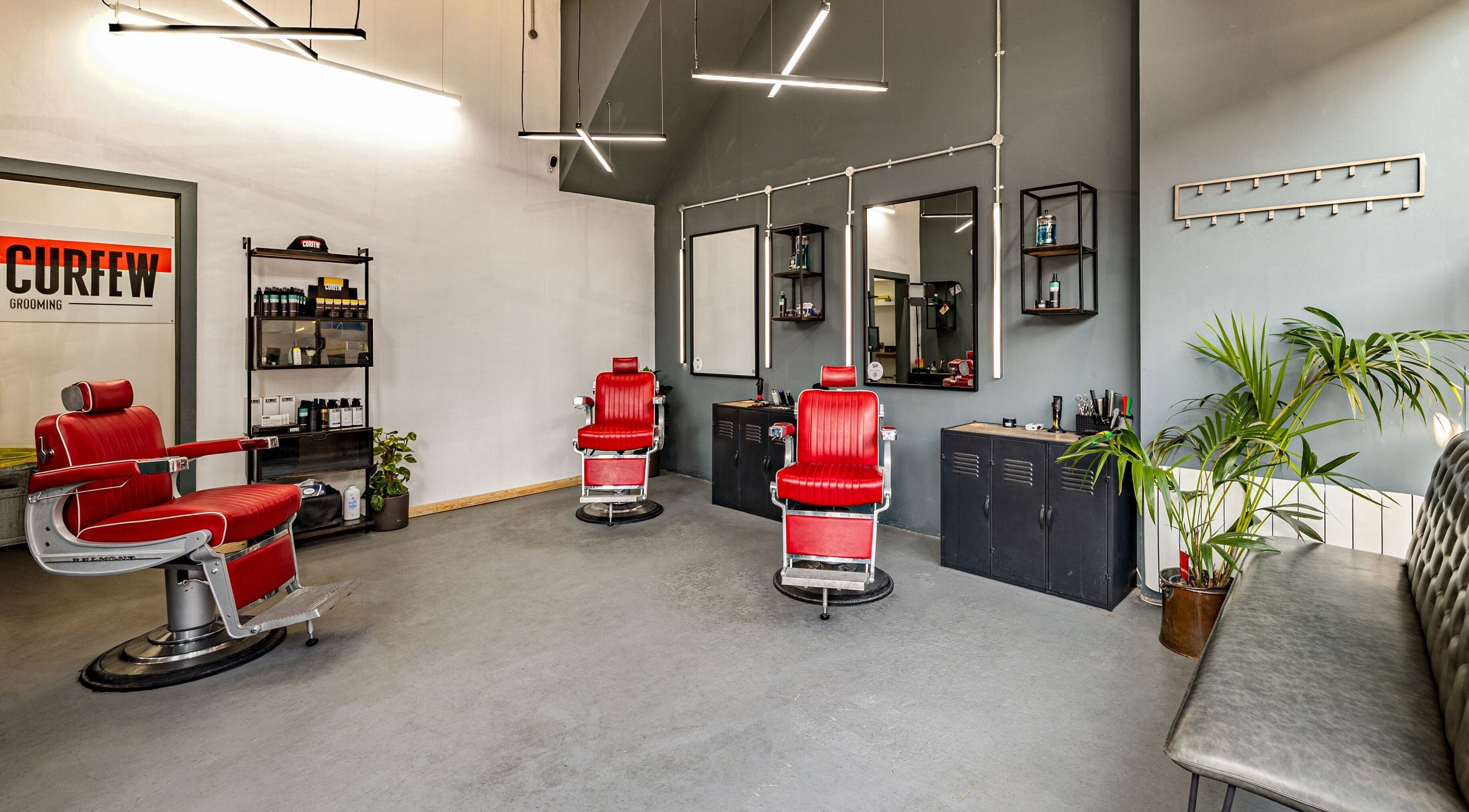 Modern barber chairs at Curfew Grooming Brixton, London, England, GB. Sleek design and inviting atmosphere.