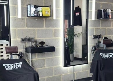 Sleek interior of Curfew Grooming Wandsworth, London, England, GB, showcasing expert barbershop design.