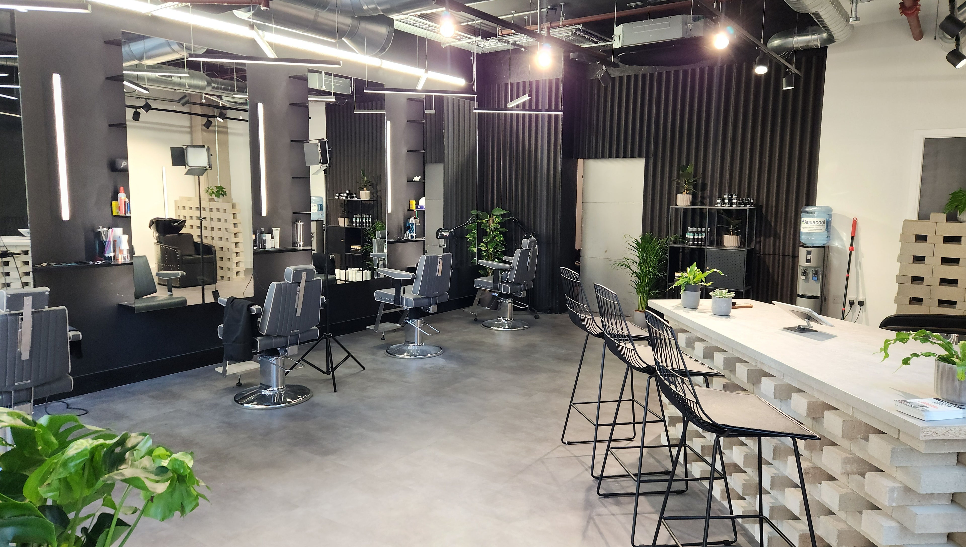 Modern interior of Curfew Grooming Wandsworth, London, England, GB with sleek barber chairs and minimalist design.