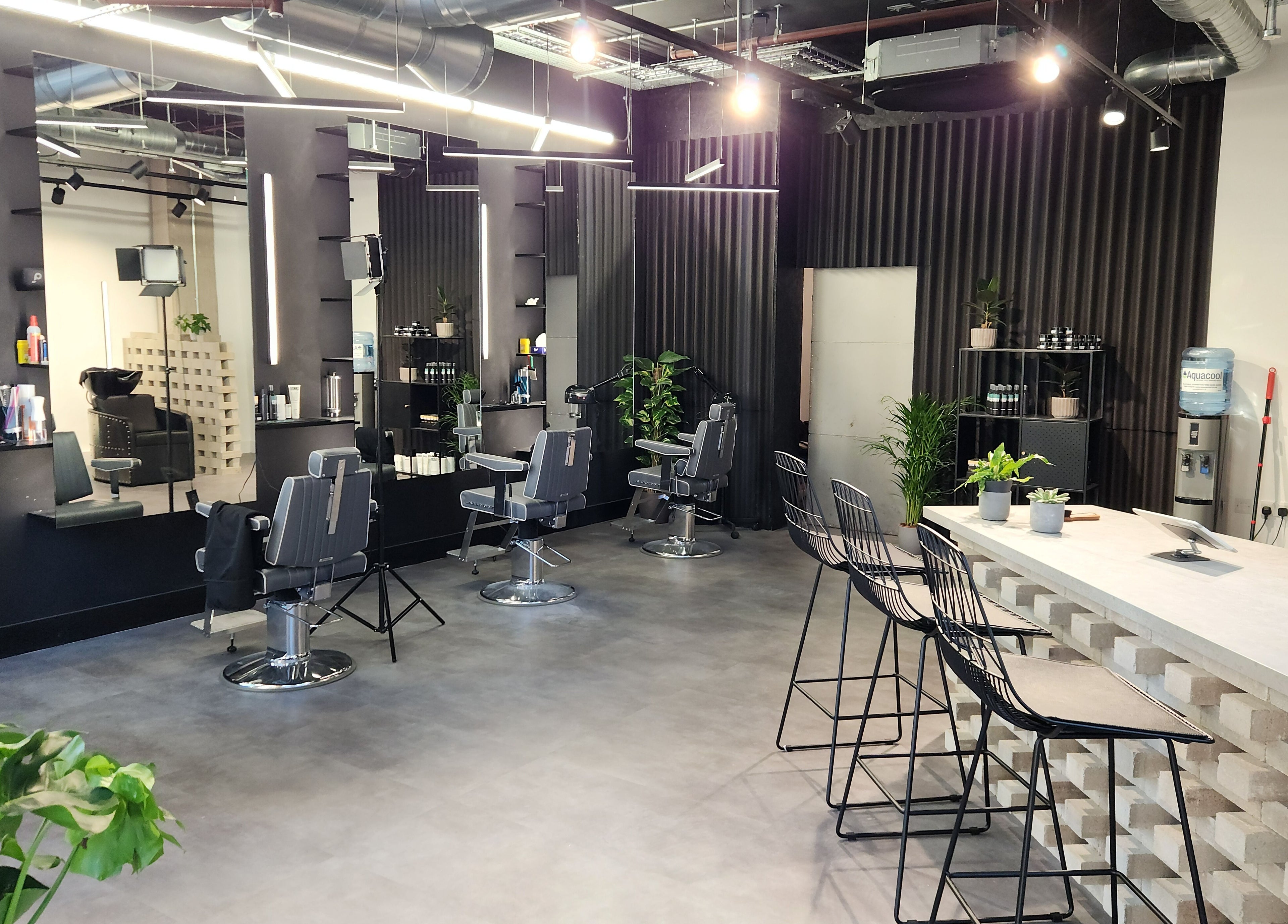 Modern interior of Curfew Grooming Wandsworth, London, England, GB with sleek barber chairs and minimalist design.