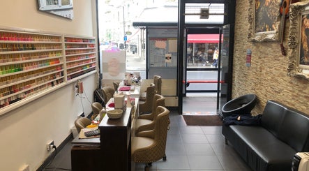 Interior of Ks Nail Salon in London, England, GB showcasing manicure stations and polish displays.
