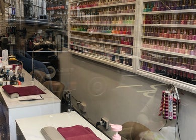 Nail polish array at Ks Nail Salon, London, England, GB, showcasing a colorful selection for clients.