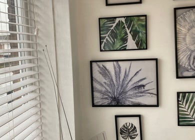 Art-filled corner at Marialice Massage & Beauty, Stevenage, England, GB, showcasing a serene Buddha and plant images.