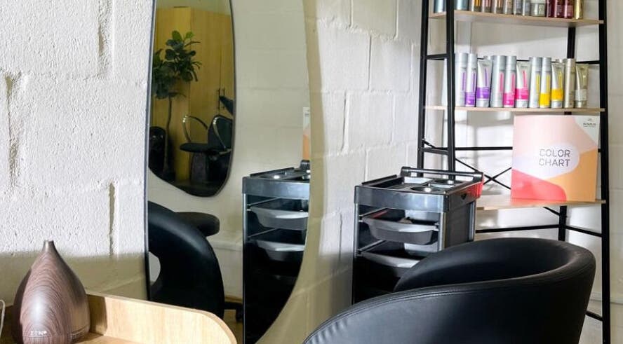 Modern styling area at Select Beauty Studio, Cape Town, Western Cape, ZA with mirror and product shelf.