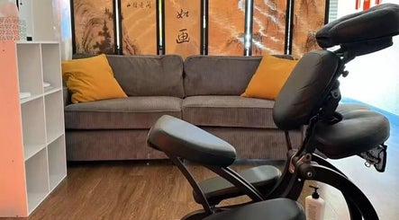 Cozy massage chair and sofa at Sunny Massage Spa, Bentonville, Arkansas, US. Ideal for relaxation.