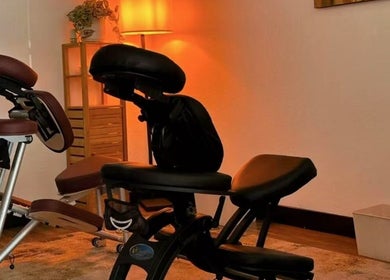 Cozy massage chair in ambient lighting at Sunny Massage Spa, Bentonville, Arkansas, US.