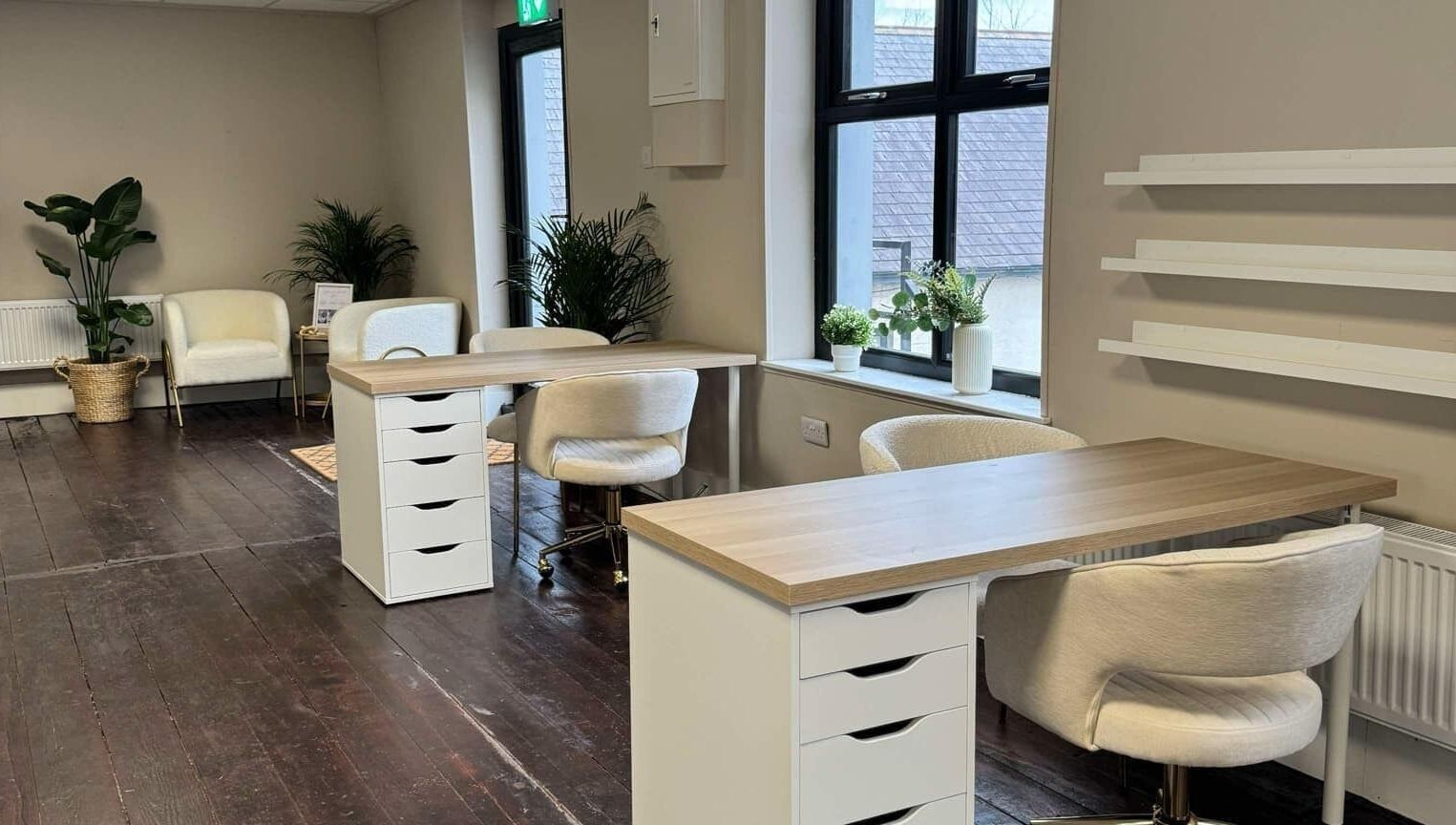 Modern nail salon interior at Loft Health & Beauty, Broughshane, Northern Ireland, GB, featuring chic workstations.