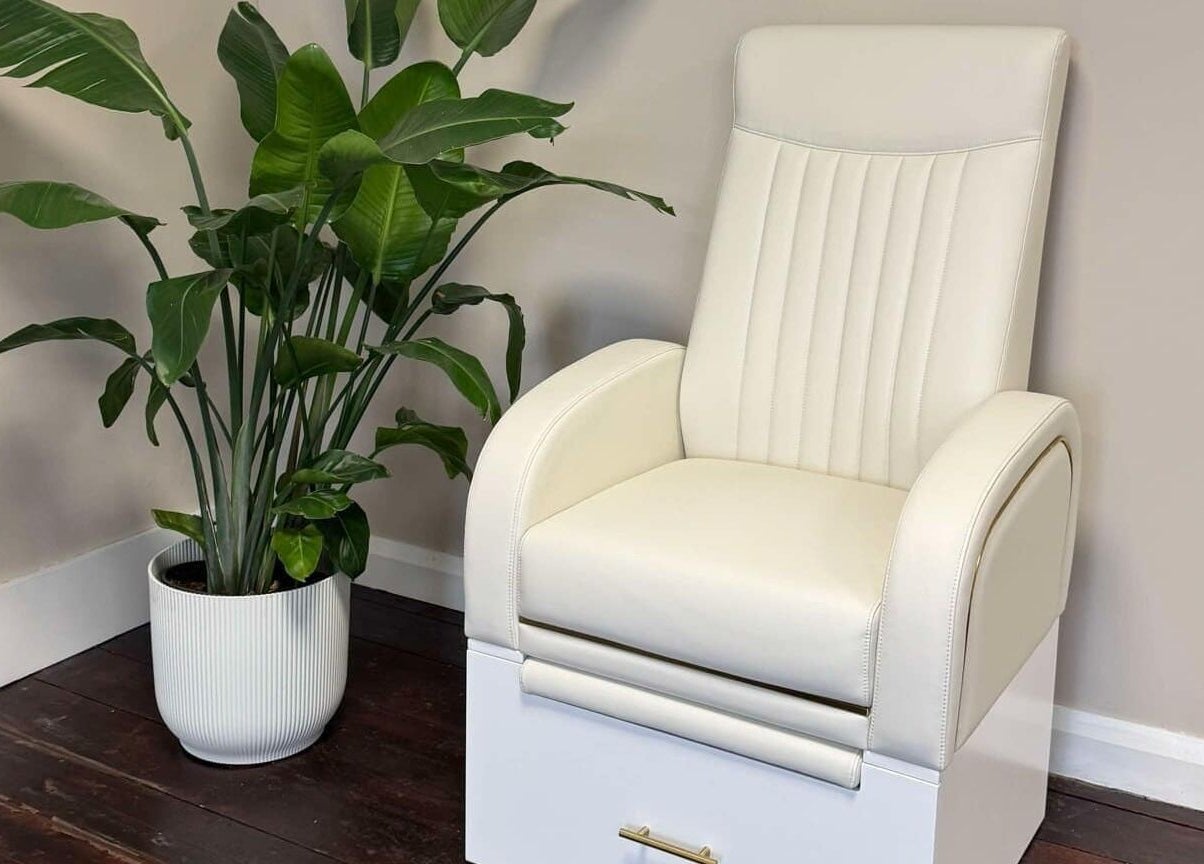 Relaxing white chair and plant at Loft Health & Beauty, Broughshane, Northern Ireland, GB.