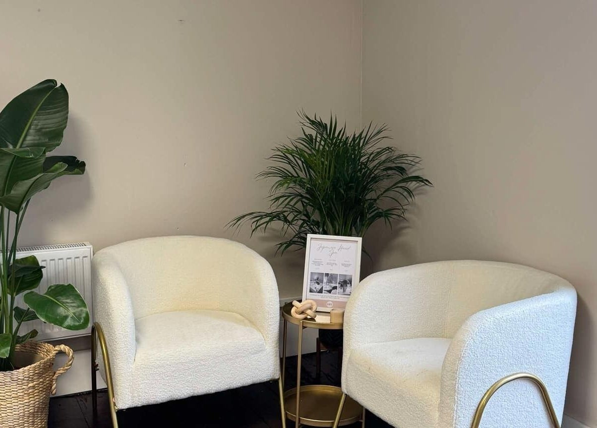 Relaxing seating area at Loft Health & Beauty, Broughshane, Northern Ireland, GB with plush chairs and plants.