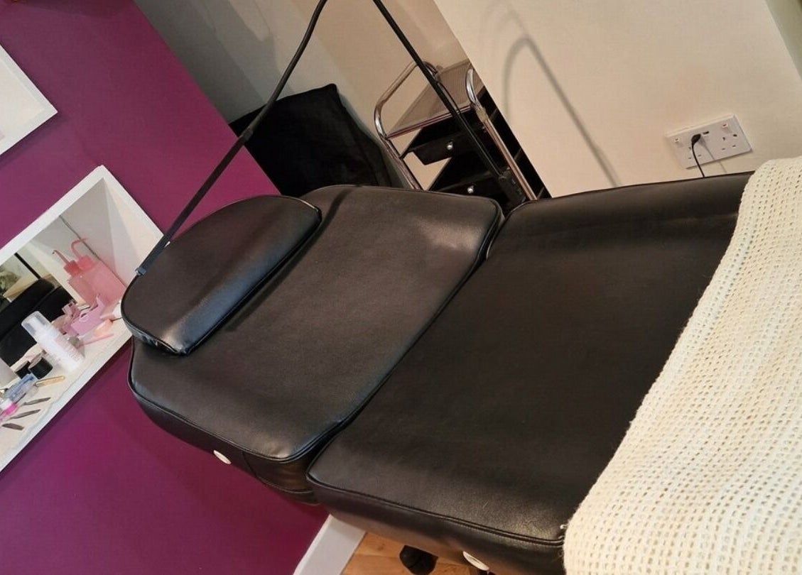 Beauty treatment bed at The Beauty Hideaway, Ludlow, England, GB. Modern interior with purple accents.