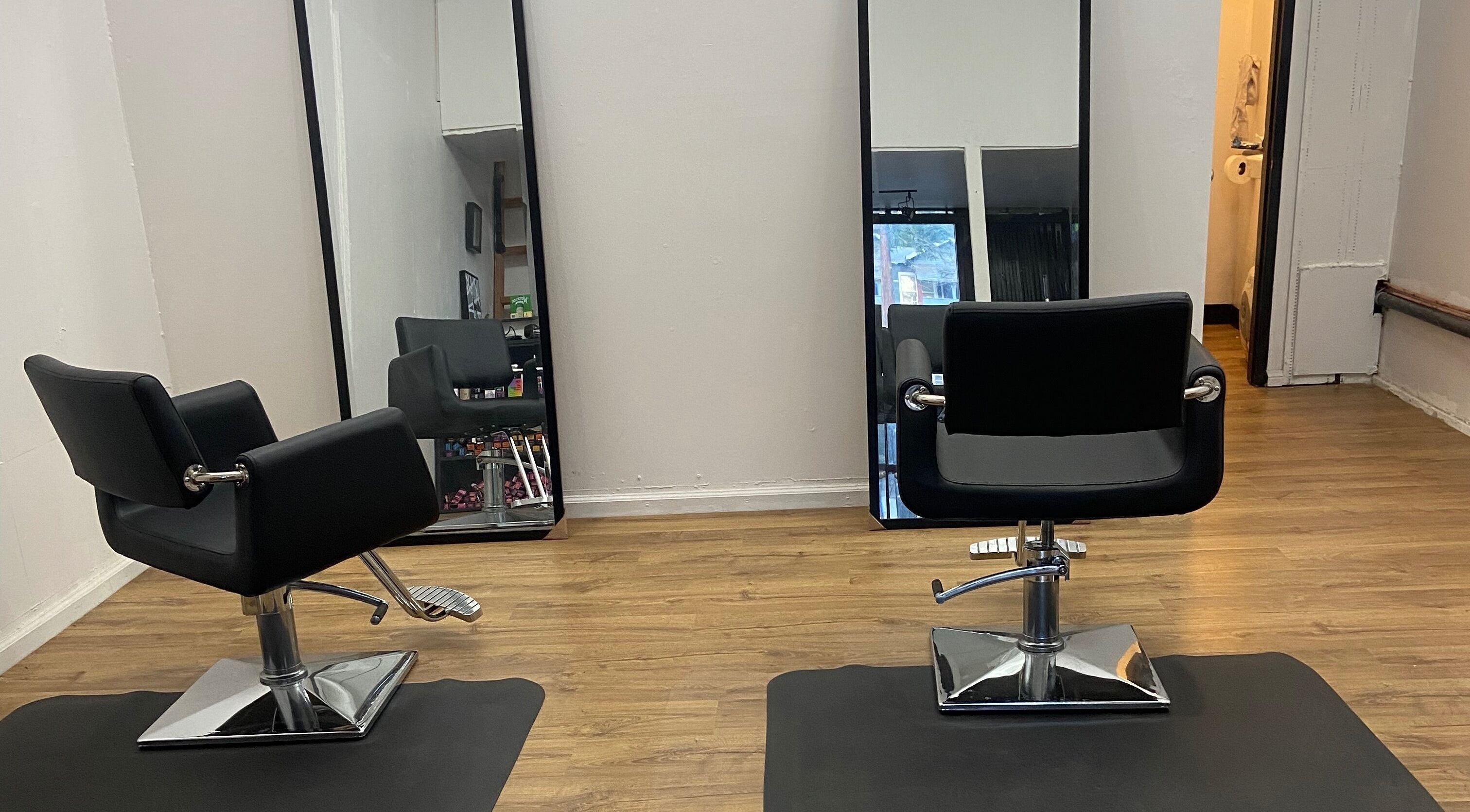 Yocatsy salon interior in Los Angeles, California, US, featuring modern styling chairs and mirrors.