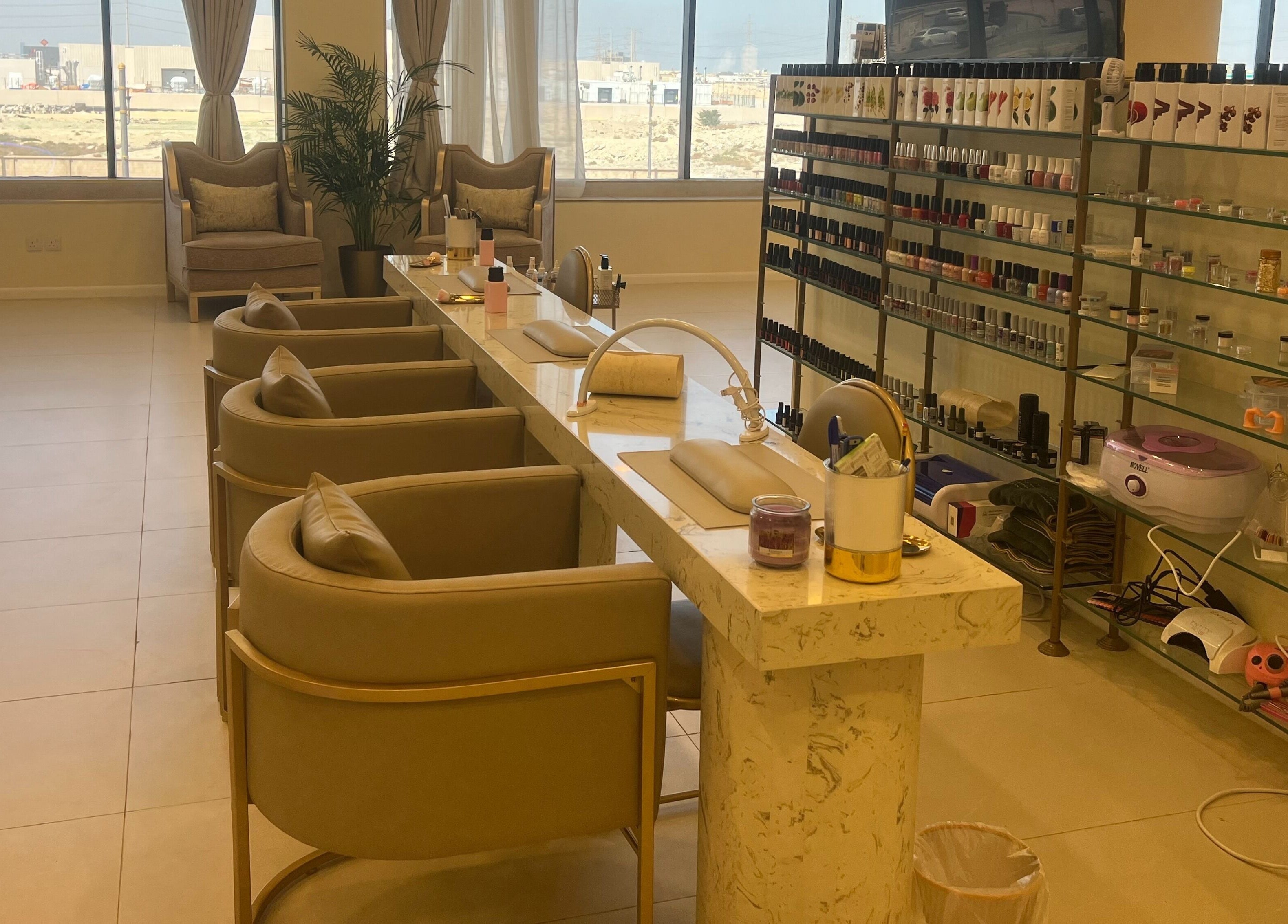 Manicure station at Hermosa Beauty Salon in Dhahran, Eastern Province, SA, featuring plush seating and nail products.