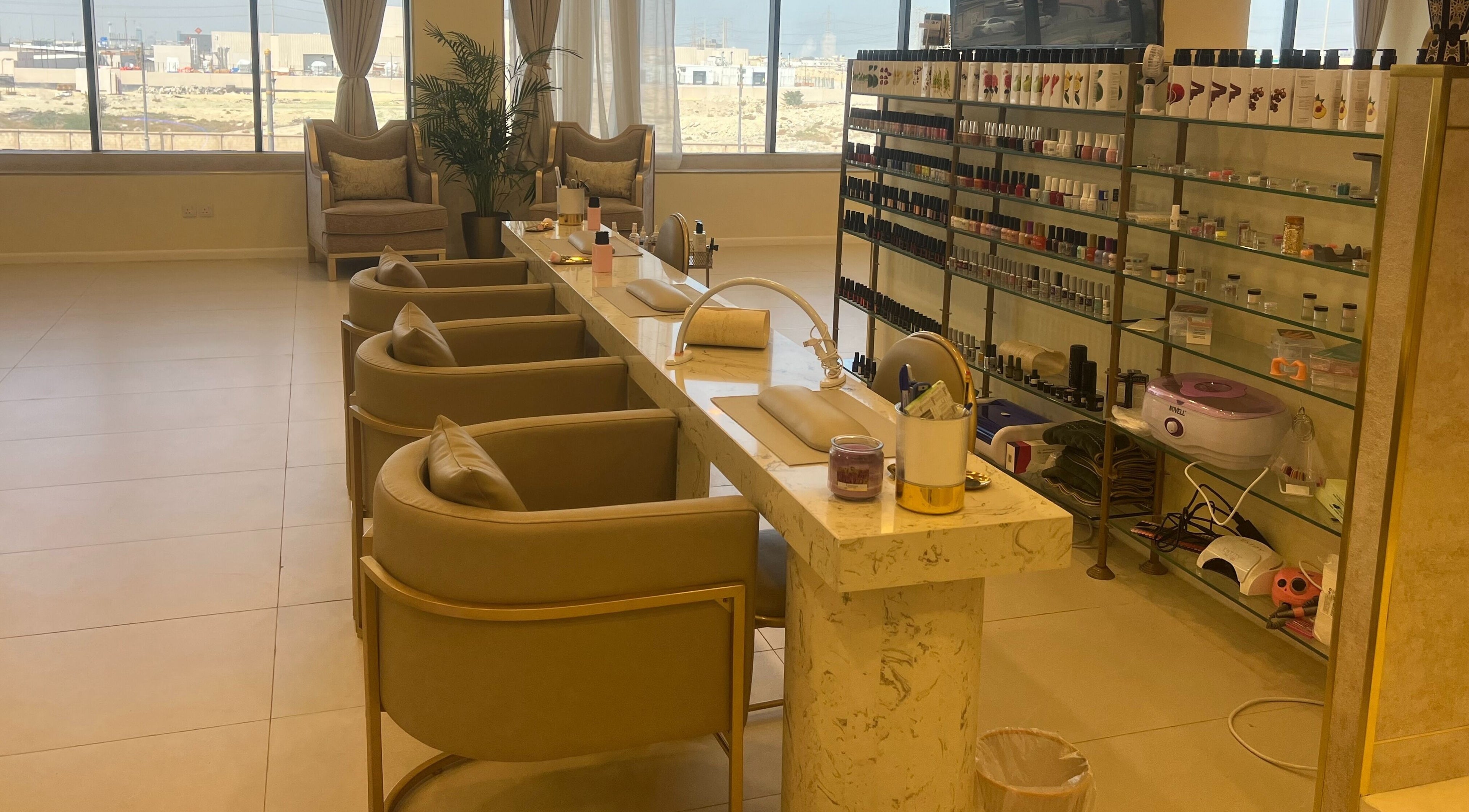 Manicure station at Hermosa Beauty Salon in Dhahran, Eastern Province, SA, featuring plush seating and nail products.