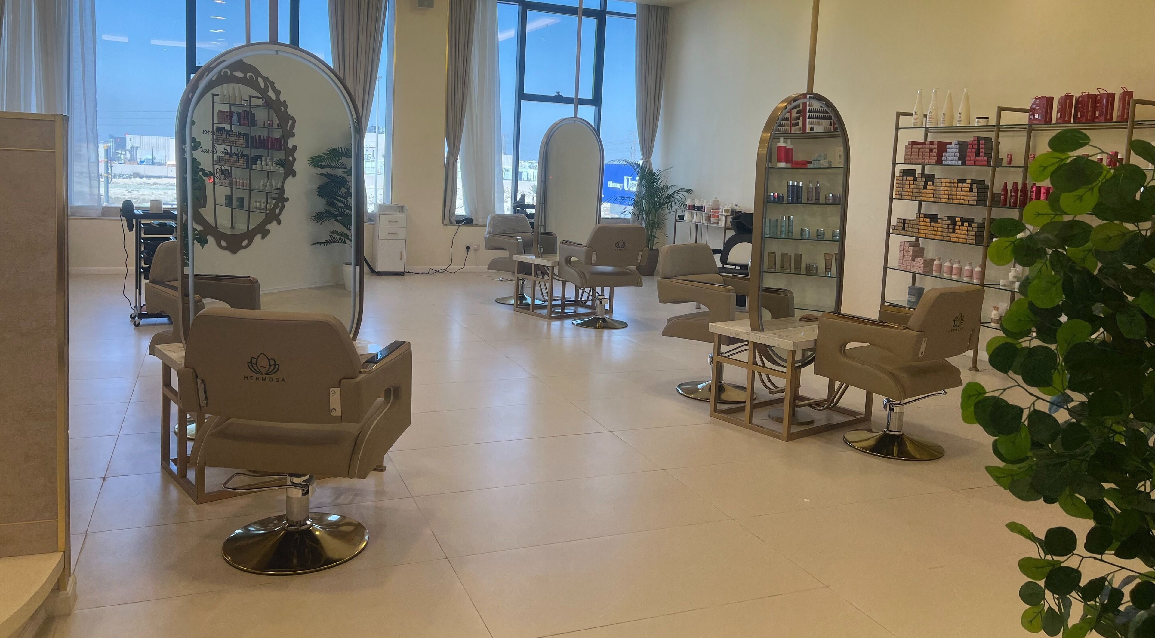 Chic interior of Hermosa Beauty Salon, Dhahran, Eastern Province, SA, featuring stylish salon chairs and bright lighting.