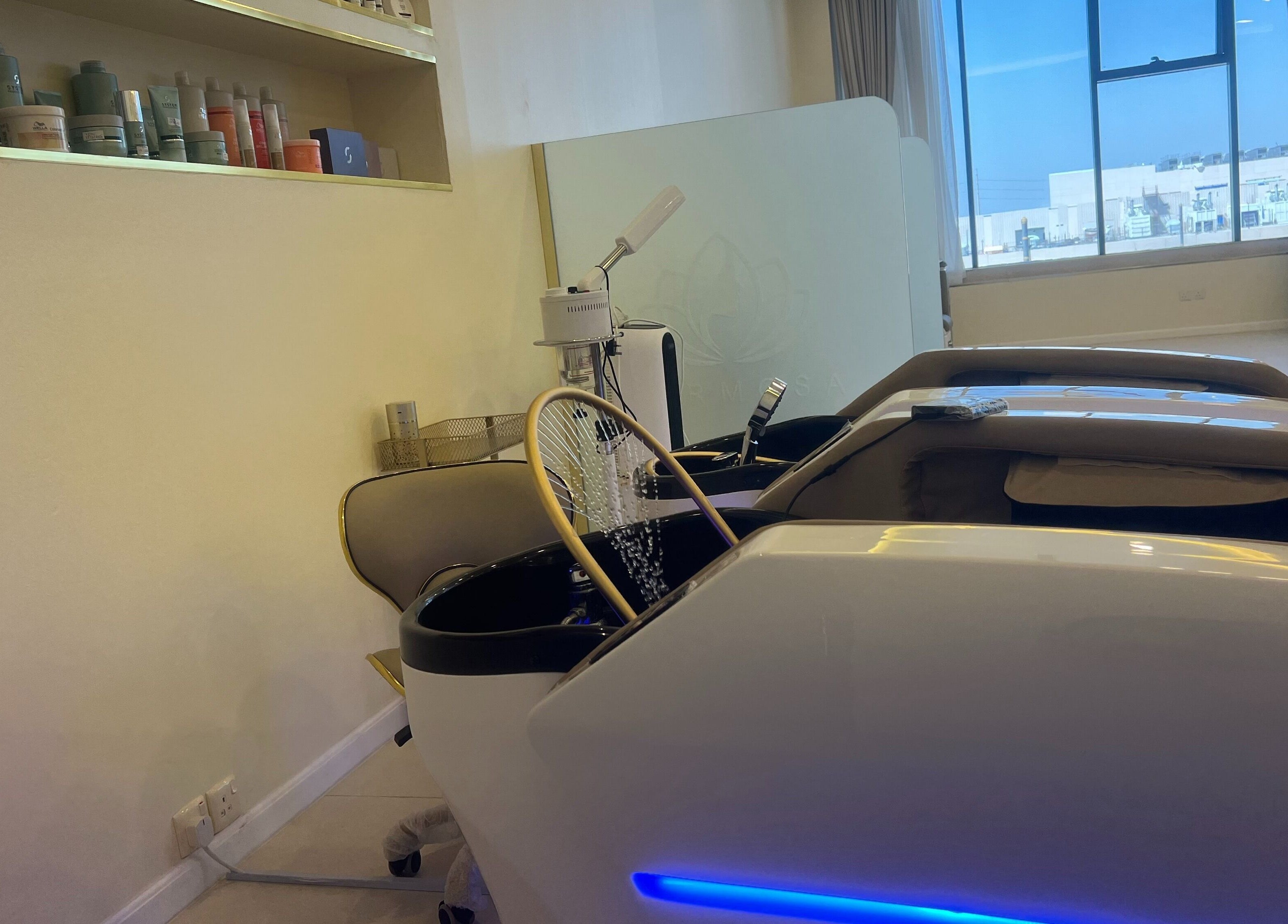 Chic interior of Hermosa Beauty Salon in Dhahran with modern spa chairs and natural light.