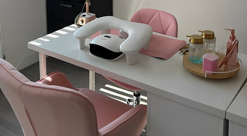 Modern nail station at CLB the salon, Winterbourne, England, GB with pink chairs and nail care tools.
