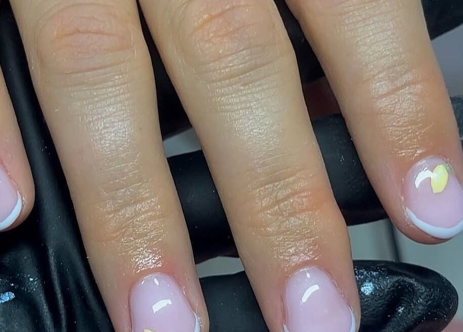 Elegant pink and white manicure with heart detail at CLB the salon, Winterbourne, England, GB.