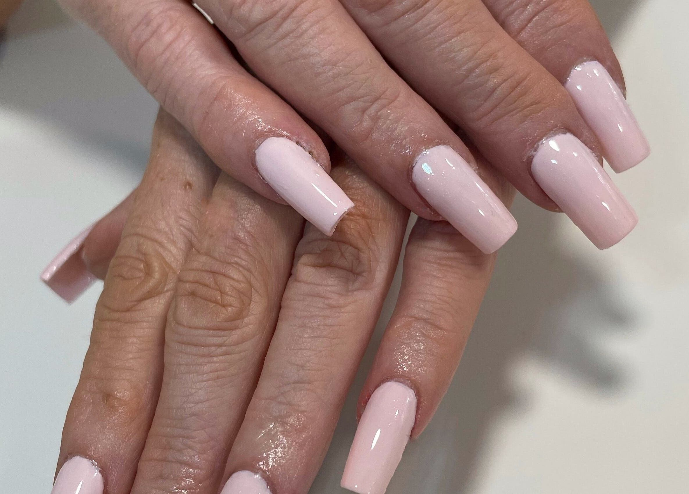 Pink manicured nails at CLB the salon, Winterbourne, England, GB.