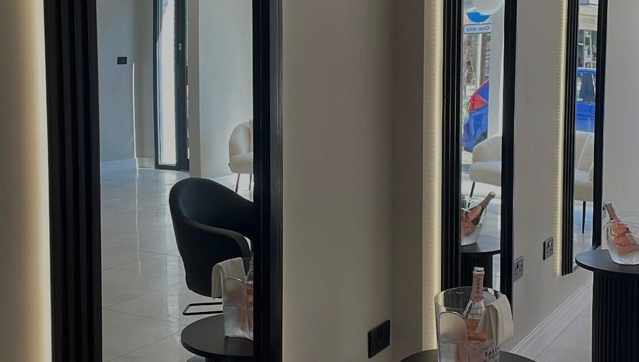 Modern salon interior at Becky With The Good Hair - Stubbington in Fareham, England, GB with sleek mirrors and chairs.