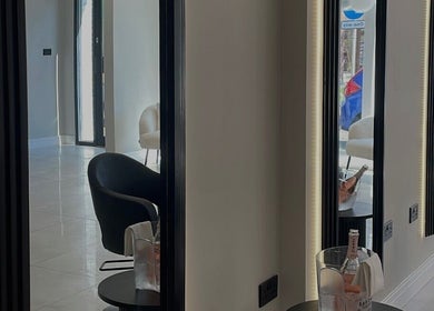 Modern salon interior at Becky With The Good Hair - Stubbington in Fareham, England, GB with sleek mirrors and chairs.