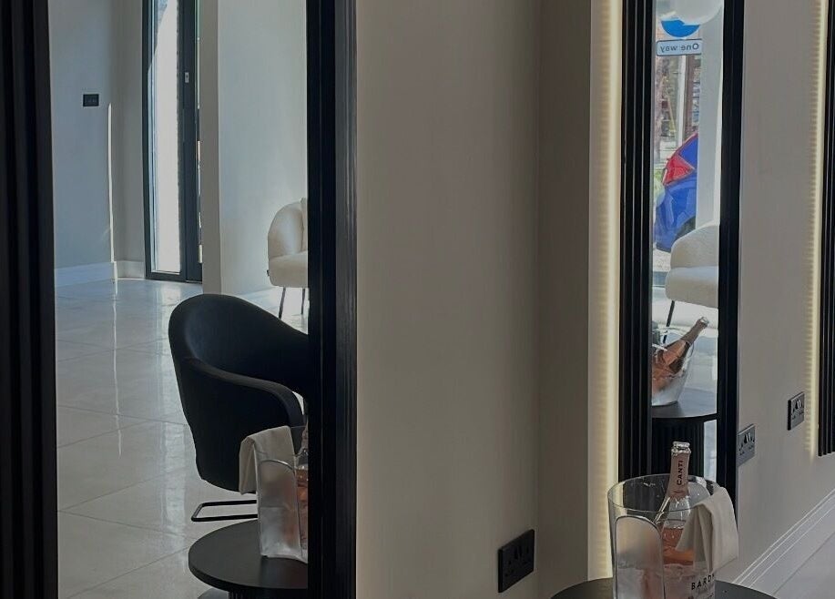 Modern salon interior at Becky With The Good Hair - Stubbington in Fareham, England, GB with sleek mirrors and chairs.